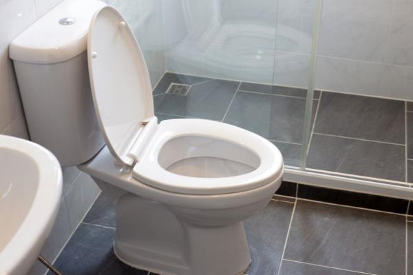 White toilet bowl on floor