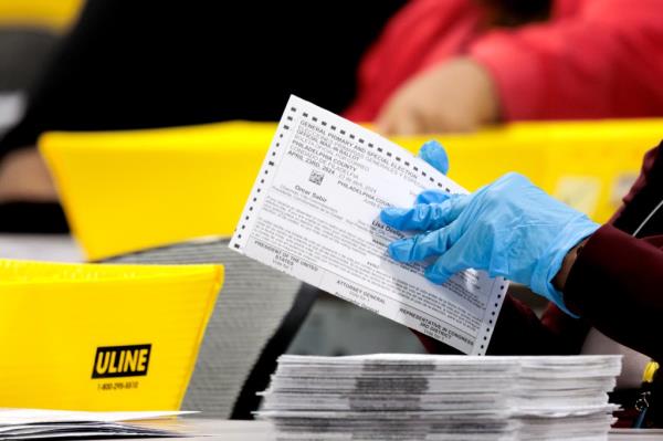 An election worker flattens ballots during the 2024 Pennsylvania primary election at the City of Philadelphia's Election Warehouse in Philadelphia, Pennsylvania, US, on Tuesday, April 23, 2024.