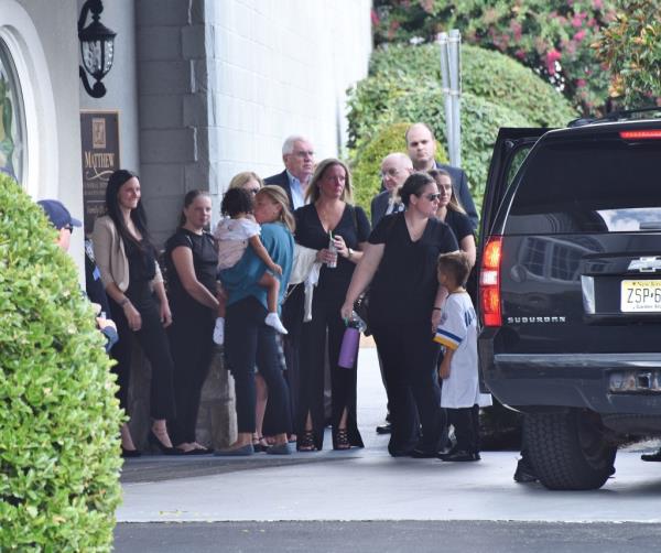 Family members of Police officer Anthony Varvaro enter the Matthew Funeral home in Staten Island 