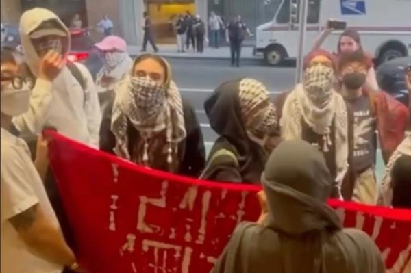 Anti-Israel protesters taunting Jewish students at the Kosher restaurant Mr. Broadway.