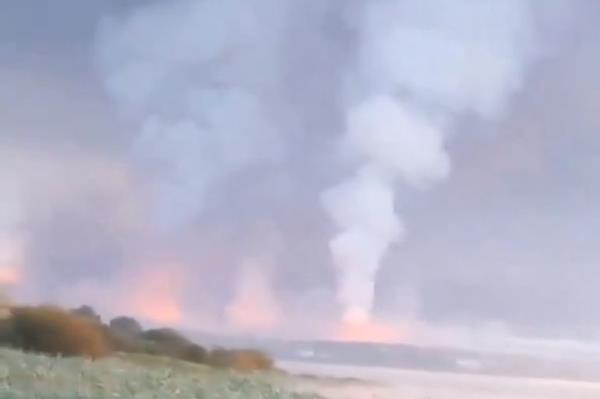 Smoke and flames rise following a Ukrainian drone attack