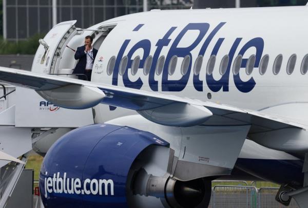 Man standing in the doorway of an airplane with JetBlue branding at Farnborough Internatio<em></em>nal Airshow, Britain, July 22, 2024.