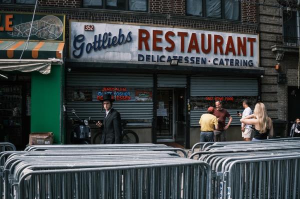 Group of people standing outside the closed Gottlieb's Jewish deli in Williamsburg, Brooklyn