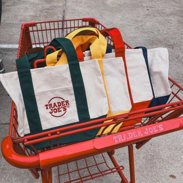 People are happily waiting in line to get a mini tote bag from Trader Joe's.