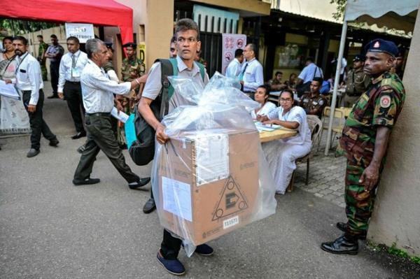 An election official transports a sealed ballot box at the end of voting in Sri Lanka’s presidential election in Colombo on September 21, 2024. (AFP)