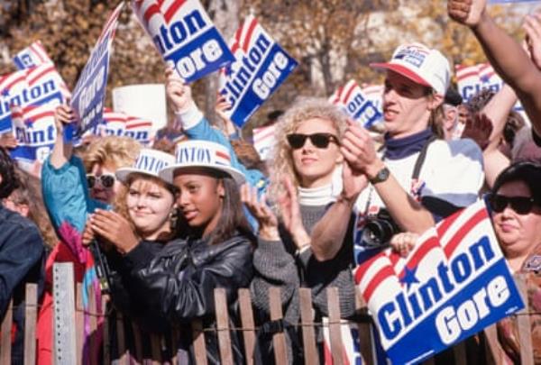 people hold ‘Clinton Gore’ signs