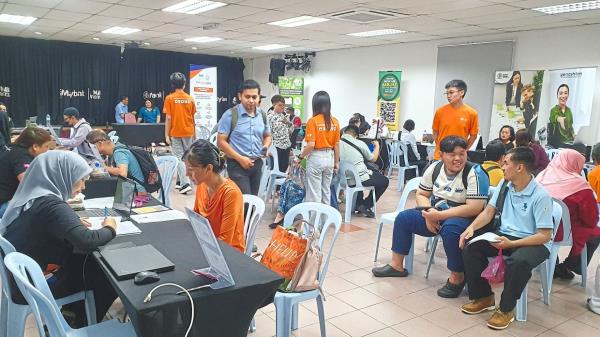 Job seekers engage with potential employers at the fair.