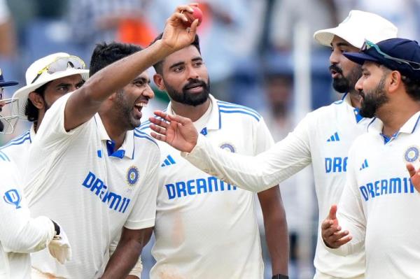 India's Ravichandran Ashwin shows the ball in his hand as he celebrates his 5-wicket haul