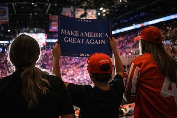 A Trump supporter holding up a "Make America Great Again" sign at the rally.