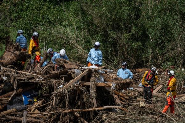 Rescue perso<em></em>nnel search for missing people in debris washed away from flooding along the Tsukada river following heavy rain in Wajima city, Ishikawa prefecture on September 23, 2024. — AFP pic