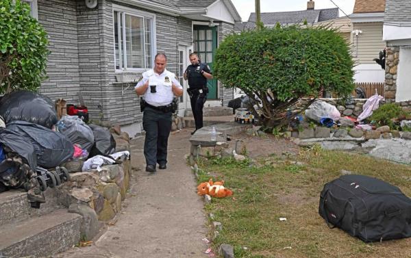 Police officers at the house wher<em></em>e the fight started.