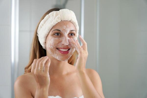 woman washing face and the side of her nose