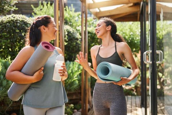 Two women take a yoga class together