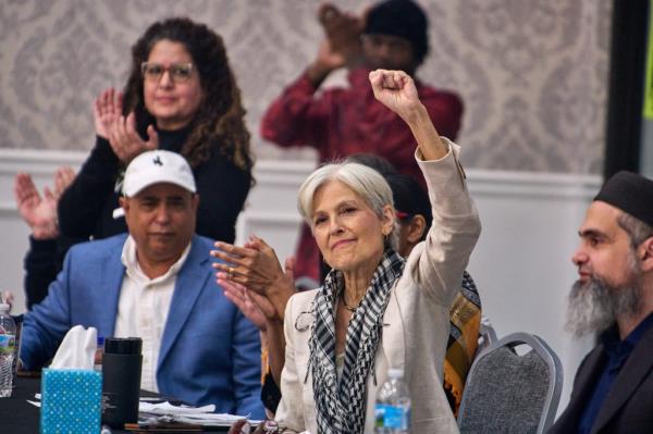 Jill Stein, 2024 Green Party presidential candidate, raising her hand during the 'Abandon Harris' campaign event at the Bint Jebail Cultural Center in Dearborn, Michigan