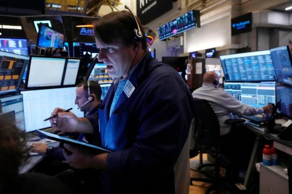 Trader Michael Milano, foreground, works with colleagues on the floor of the New York Stock Exchange, Monday, Nov. 4, 2024.