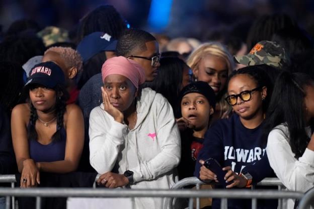 Four young women look dismayed at a political watch party. One is resting her chin in her hands.