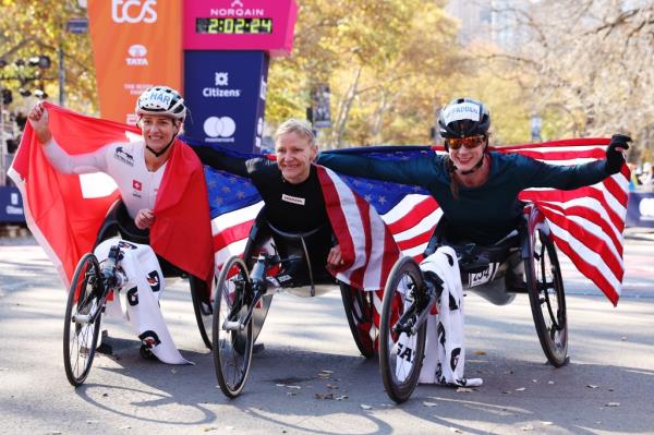 Manuela Schar of Switzerland, Susannah Scaroni of the United States, and Tatyana McFadden of the United States pose with flags after placing in the top 3 of the Professio<em></em>nal Womenâs Wheelchair Division during the 2024 TCS New York City Marathon on November 03, 2024 in New York City.