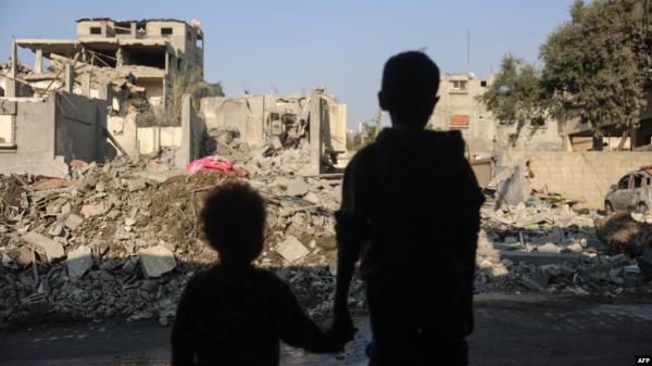 Children stare at the destruction following an Israeli strike in the Nuseirat refugee camp in the central Gaza Strip on Nov. 7, 2024.