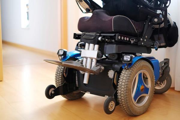 a parked power wheelchair in a hallway