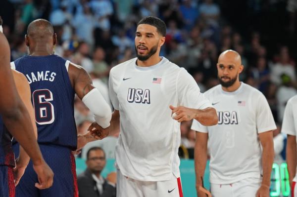 LeBron James #6 of Team USA high fives Jayson Tatum #10 of Team USA while Derrick White #8 of Team USA looks on during the Men's Gold Medal Game 