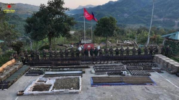 Arakan Army fighters pose with arms, ammunition and military devices seized from the junta in Rakhine state in January 2024.