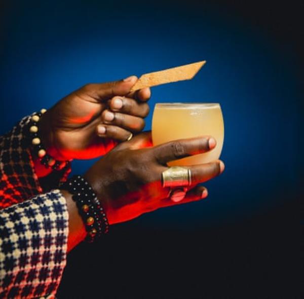 A man’s hands holding a cocktail