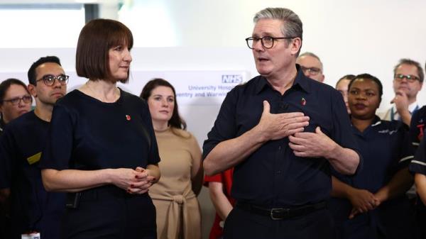 Keir Starmer and  Rachel Reeves speak with members of staff during a visit to University Hospital Coventry and Warwickshire in Coventry.
Pic: AP