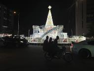 A man rides a motorcycle taxi past Christmas decorations on a street in Lagos, Nigeria. (IMAGE: AP PHOTO)