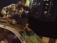 Screengrab of a viral video shows a man perched atop a speeding taxi with a broken windshield on Mumbai’s Santacruz flyover. (IMAGE: @HateDetectors/X)