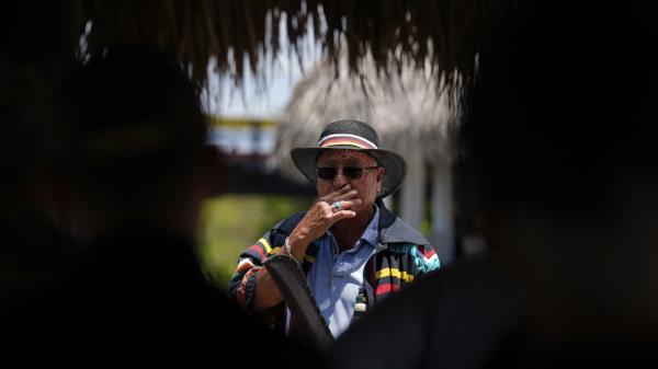 Miccosukee Tribal elder Michael Frank, top left, rides an airboat with members of a task force that brings together federal, state, tribal and local agencies working to restore and protect the Florida Everglades, on a field visit to the Miccosukee Indian Reservation ahead of a task force meeting hosted by the tribe, Wednesday, April 24, 2024 on the Fla. (AP Photo/Rebecca Blackwell)