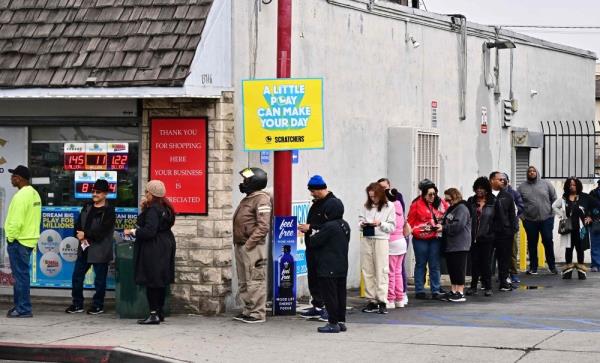 People wait in line to purchase their Mega Millions lottery ticket from a liquor store wher<em></em>e winning tickets have been sold on December 27, 2024 in Hawthorne, California. — AFP pic 