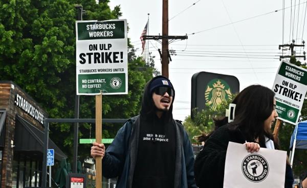 Starbucks workers hold signs as they picket during a strike in front of a Starbucks to demand collective bargaining agreements on December 24, 2024 in Los Angeles, California. Starbucks Workers United, which says it represents baristas at hundreds of outlets around the country, said its action was aimed at forcing the company to improve pay and co<em></em>nditions after mo<em></em>nths of negotiations that it said have gone nowher<em></em>e. — AFP pic