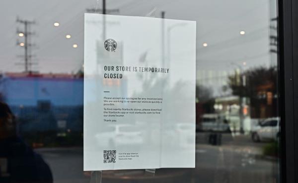 A sign at a Starbucks informs customers of temporary closure as workers were due to picket in front of the temporarily closed store on December 24, 2024 in Los Angeles, California, as the natio<em></em>nwide strike co<em></em>ntinues for the fifth day at various locations across the country. — AFP pic