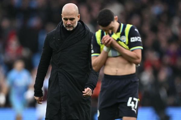 Manchester City's Spanish manager Pep Guardiola reacts to their defeat as he walks across the pitch after the English Premier League football match between Aston Villa and Manchester City. — AFP