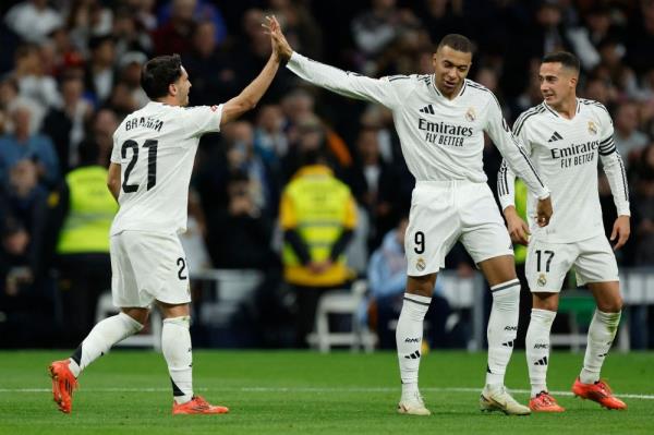 Real Madrid’s Brahim Diaz celebrates with Kylian Mbappe after scoring his team’s fourth goal during the Spanish league football match between Real Madrid CF and Sevilla FC. — AFP