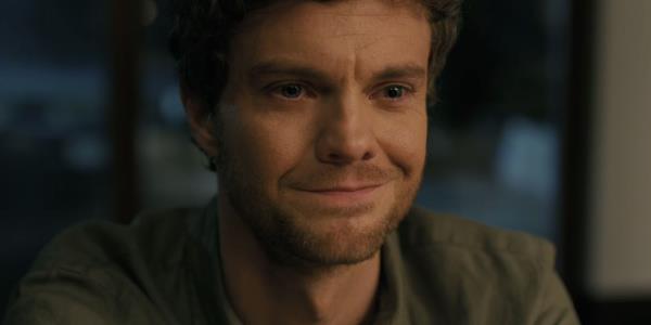 Jack Quaid smiling in Companion