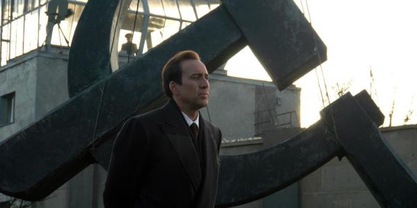 Nicolas Cage as Yuri Orlov walking among Russian salvage in Lord of War