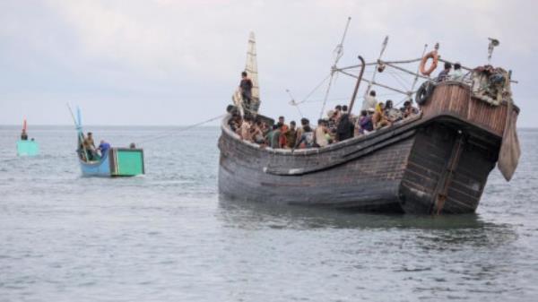 A boat with Rohingya refugees is towed offshore after the nearby community gave them water and food but did not allow them to land on the beach in Pineung, Aceh province on Nov 16, 2023. Photo: AFP