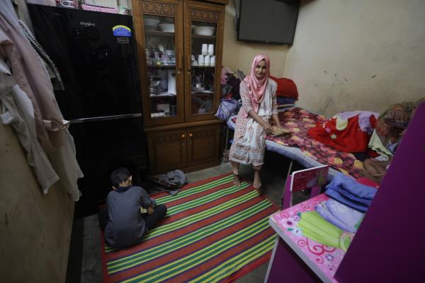 Simran lives in a house with two 9x7 feet rooms on different floors, with her parents and three younger sisters.