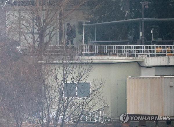 A person believed to be a security guard patrols at impeached President Yoon Suk Yeol's official residence in Seoul on Jan. 13, 2025, one week after a court issued a second warrant to detain Yoon in co<em></em>nnection to his short-lived imposition of martial law. (Yonhap)