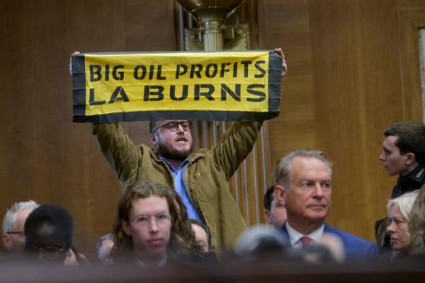 A protester interrupts Wright, Trump's nominee to be secretary of energy, as he testifies during a Senate Energy and Natural Resources Committee hearing for his pending co<em></em>nfirmation on Capitol Hill, Wednesday, Jan. 15, 2025, in Washington.